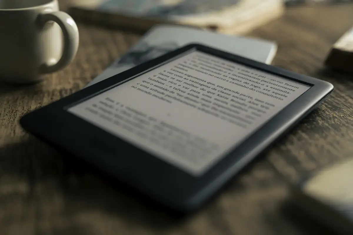 An e-reader showing a page of text on a wooden table