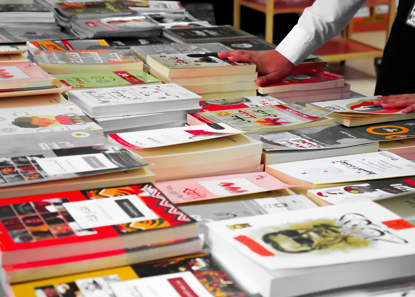 A table covered with displayed books at a book fair